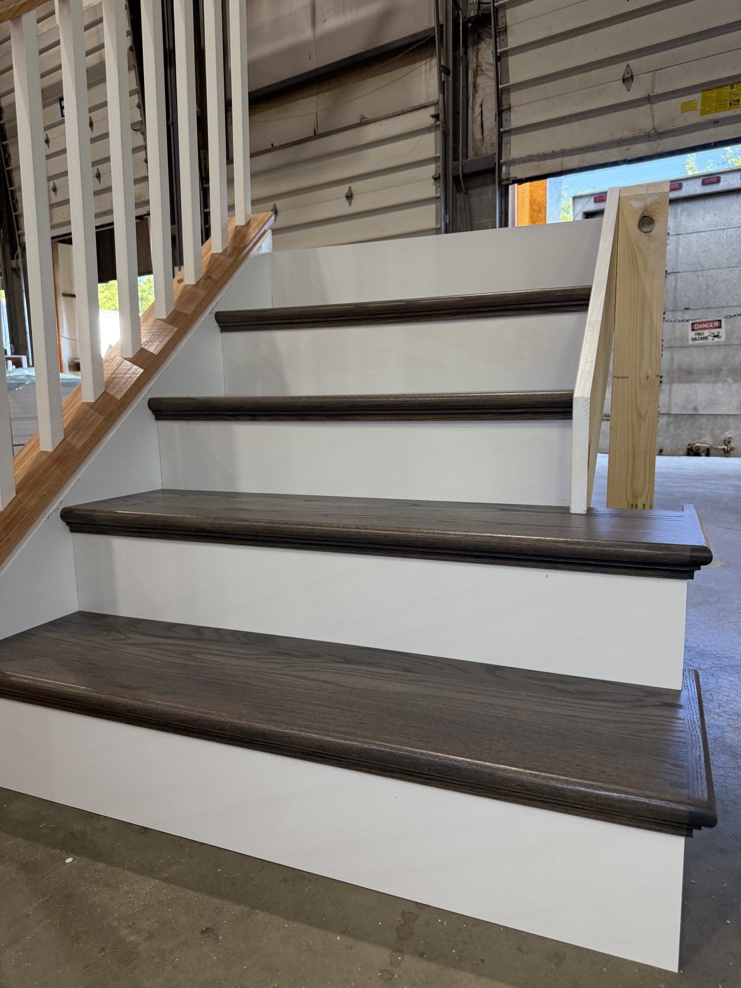The same Apex staircase capped in stained hardwood